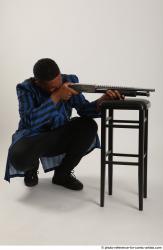 Man Adult Average Black Kneeling poses Casual Fighting with shotgun